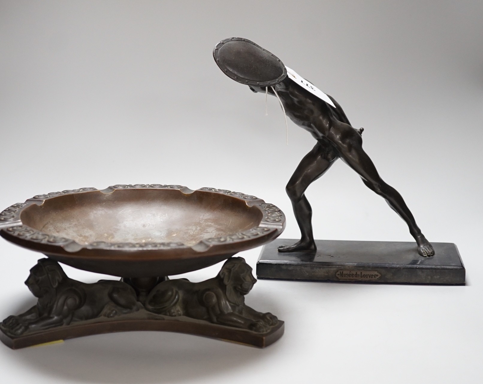 A large bronze dish, on triform lion base, and a bronze-finished warrior, dish 28cms diameter